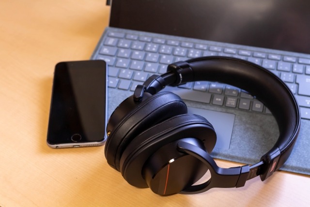 スマホと黒いワイヤレスヘッドホン