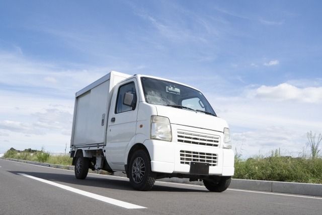 車道を走る白い軽トラック