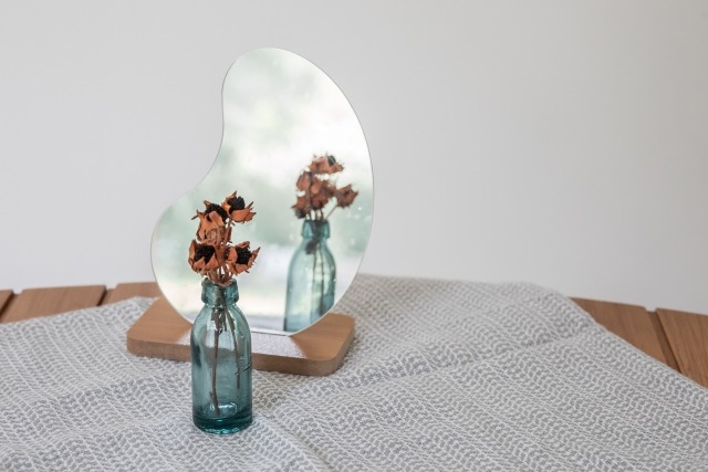 インテリアの変形ミラーとドライフラワー